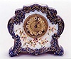 AN ENGLISH VICTORIAN CHINA CASED SHELF CLOCK,