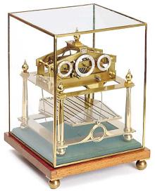 Elegant small Congreve clock - 9 1/2" high x 7 1/2" x 7 1/2". — Antique Clocks Price Guide