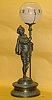 Nightlight clock in which a Cavalier nightlighter holds a staff with a numbered glass bowl on top.