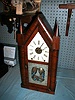 8-Day Steeple clock with reverse painting on lower door glass.