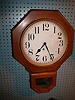 E. Ingraham Clock Company 8-day wall clock with Arabic numerals.