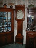 Eight-day Pennsylvania tall case clock with rolling pin top.