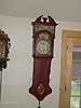 Double hooded Dutch 'tail clock' with animation on dial.