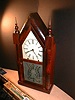 8-day steeple clock with etched pattern on lower door glass.