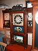 Triple decker mantle clock with reverse-painted tablets and eight-day strap movement.