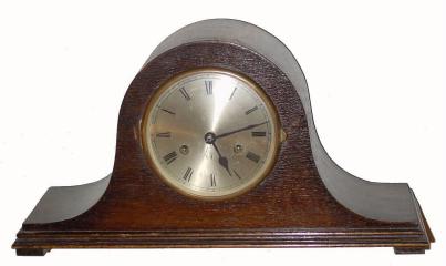 C.1920, English, ÒTambourÓ, or Napoleon hat clock, dark oak case, 8-day, gong strike. — Antique Clocks Price Guide