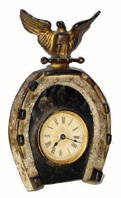 C.1878 Ansonia Clock Co., 30-hour novelty timepiece, in the shape of a horse shoe with an spread eagle on top (all a single casting), and the rear strut is a cast horseÕs leg. We couldnÕt find this in the catalog as the examples you find there are later. — Antique Clocks Price Guide