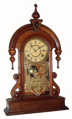 C.1881 Waterbury Clock Co., ÓParisÒ, 8-day time/strike walnut mantel clock. This looks to be a variation on this model as the lower sidepieces are of a slightly different design and the finial and drops are more robust. — Antique Clocks Price Guide