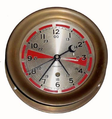 C.1967 Chelsea Clock Co., 8-day Radio Room timepiece with 24-hour dial with a secondary hour hand for Greenwich Mean Time in a cast brass case with screw on bezel. This timepiece with referred to as the ÒZuluÓ by maritime shipping. The red areas on the dial reflect periods of silence observed by radio operators to monitor for distress signals. Note silver hour hand showing in red area. — Antique Clocks Price Guide