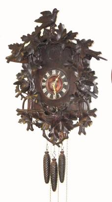 C.1900, German, large cuckoo and quail clock, 3-weight, quarter strike with excellent bird carvings. — Antique Clocks Price Guide