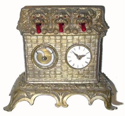 C.1870, Austrian, Meyers, Triple Dog animated panting dog novelty, 3 terriers sticking their heads out of a picnic basket. — Antique Clocks Price Guide