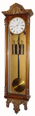 C.1840, Austrian ÓBiedermeierÒ, 3-Wt Grand Sonnerie wall clock in a slender case with small smooth corner columns, each with a small robed figure at the top. — Antique Clocks Price Guide