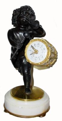 C.1885, French, ÒMini MusicÓ Bronze and Marble, mantel clock, 8-day platform timepiece. A bronze child holds a trumpet in his left hand and a drumstick in his right hand, the tiny clock-works held by his drum. — Antique Clocks Price Guide
