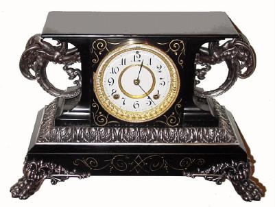C.1904, Ansonia ÓBELGIUMÒ, iron cased mantel clock with two large winged griffins, 8-day time and strike. — Antique Clocks Price Guide