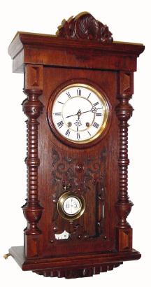 C.1900, Lenzkirch, Quarter Striking wall clock, serial number 1,368,516, in an oak case with turned half columns and carved accents. — Antique Clocks Price Guide