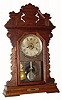 C.1890, Seth Thomas, Walnut Gingerbread clock with leveling spirit, 8-day time and strike with alarm. 
