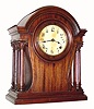 C.1920, William L. Gilbert Clock Co., 8-day time/strike mahogany mantel clock. We couldnÕt find this particular model in the Gilbert catalog, but it is very good looking with 4 Corinthian columns, arched top and shaped sides. 
