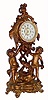 C.1910, New Haven Boudoir clock, 30-hour, gilded spelter with ÓbrilliantÒ sash and fancy porcelain dial. Note pleasant motif, with clock held aloft by 2 cherubs and a happy looking porpoise on the base. 