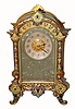 C.1890, French, Ormolu and Enamel desk clock with silvered floral mask and profuse decorations on the side of the case. 