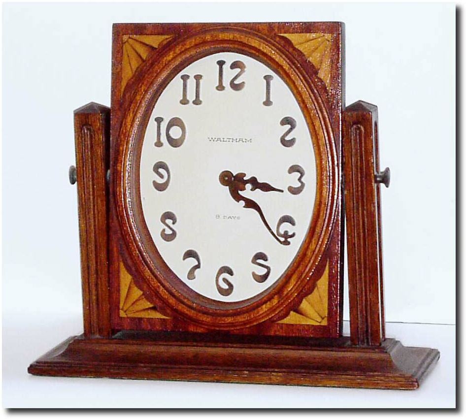 C.1925, Waltham Clock Co., a wonderful little mahogany desk clock with Art Nouveau styled hands and numerals (raised bronze). — Antique Clocks Price Guide