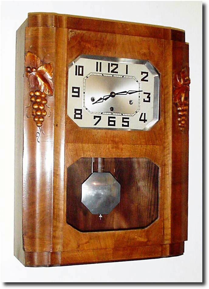 C.1930, French, Westminster Chime Wall clock in the Art Deco style, carved grapes and leaves adorning the door. — Antique Clocks Price Guide