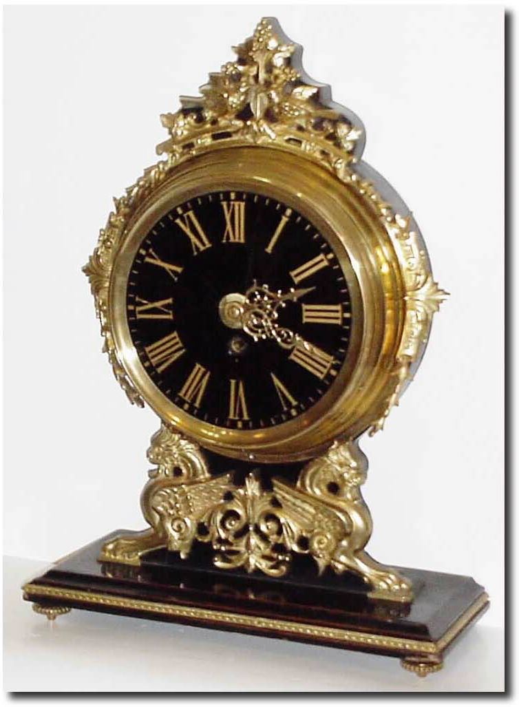 C.1900, French, Brass over wood mantel clock with a black glass dial. — Antique Clocks Price Guide
