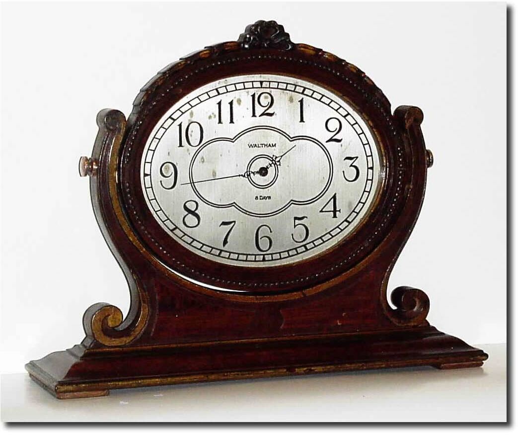 C.1925, Waltham Clock Co., 8-day Boudoir clock, the oval frame bearing the clock suspended in a yoke with turn screws on either side. — Antique Clocks Price Guide