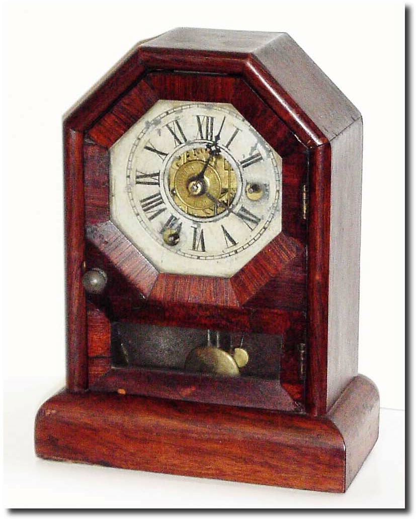 C.1870, Seth Thomas, Mini Cottage, time and alarm in rosewood octagon top case, and in fair condition. — Antique Clocks Price Guide