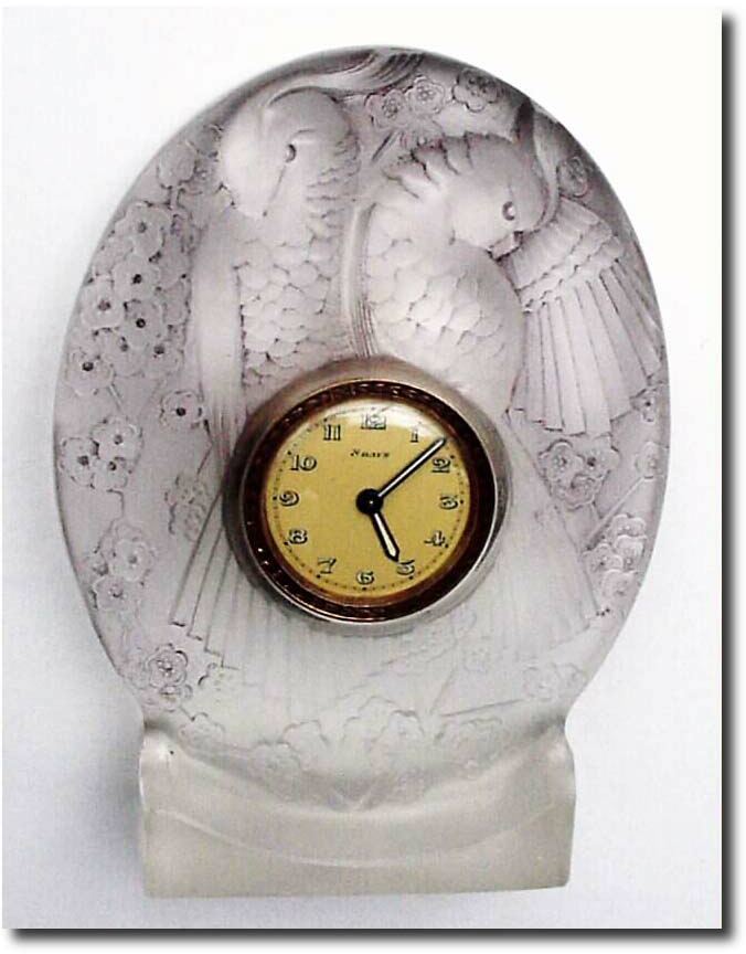 C.1910, French, Glass Desk Clock, with 8-day lever movement, the case is heavy frosted crystal in relief, showing two small parrots or love birds among the flowers. — Antique Clocks Price Guide