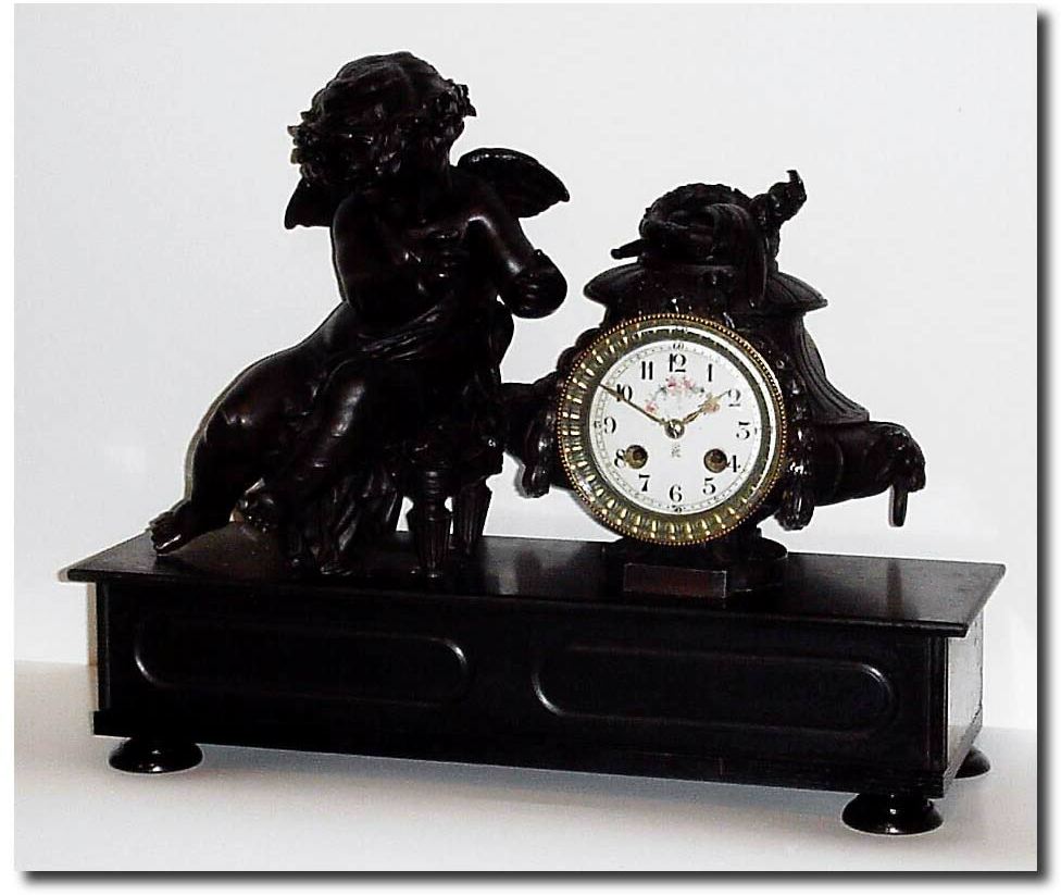 C.1895, French, Patinated Spelter, Figural clock of a large winged cherub. — Antique Clocks Price Guide