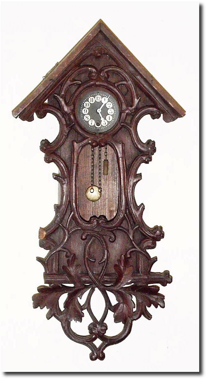 C.1930, German, Black Forest Mini Wall clock, in a carved case of oak leaves and branches Ö has more detailed carving than any of this group, but without the top trim, and the case with dry splits. — Antique Clocks Price Guide