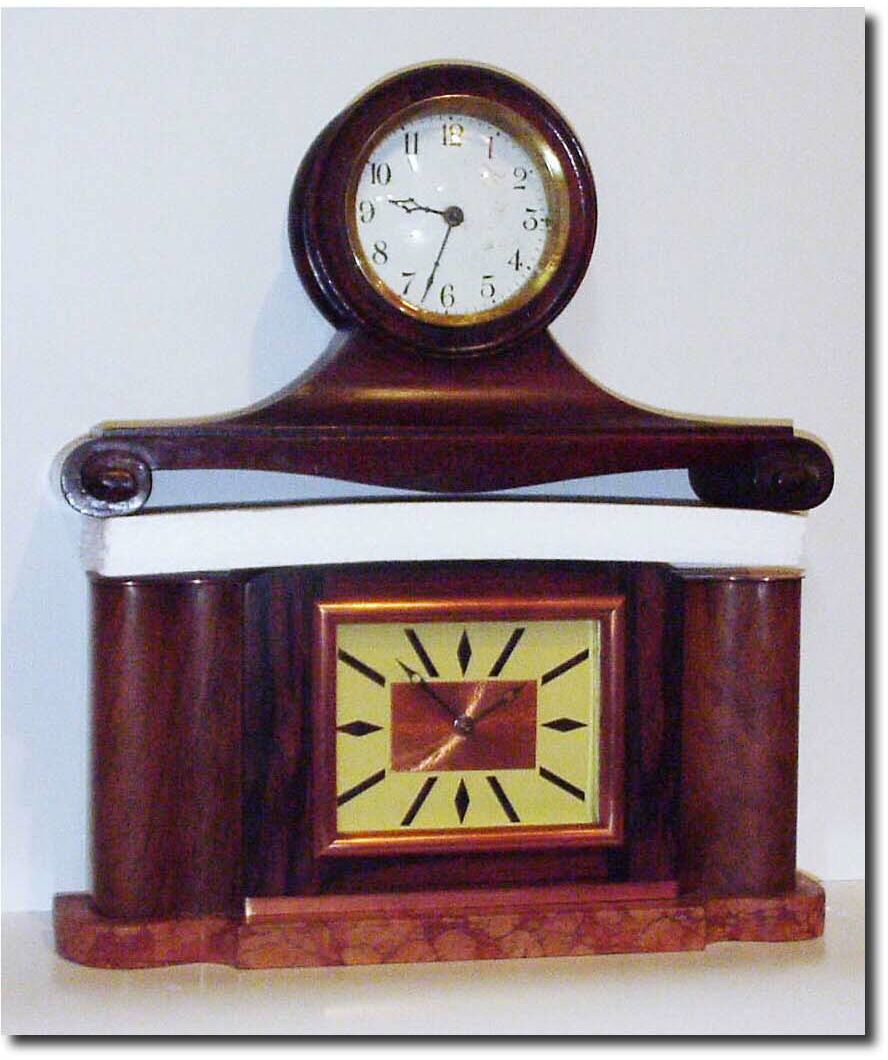 A lot of two 30 hour shelf clocks: One mahogany tambour with cracked porcelain dial, running; plus a walnut veneer on brown onyx desk clock (C.1950), with copper bezel and dial center, also running. — Antique Clocks Price Guide