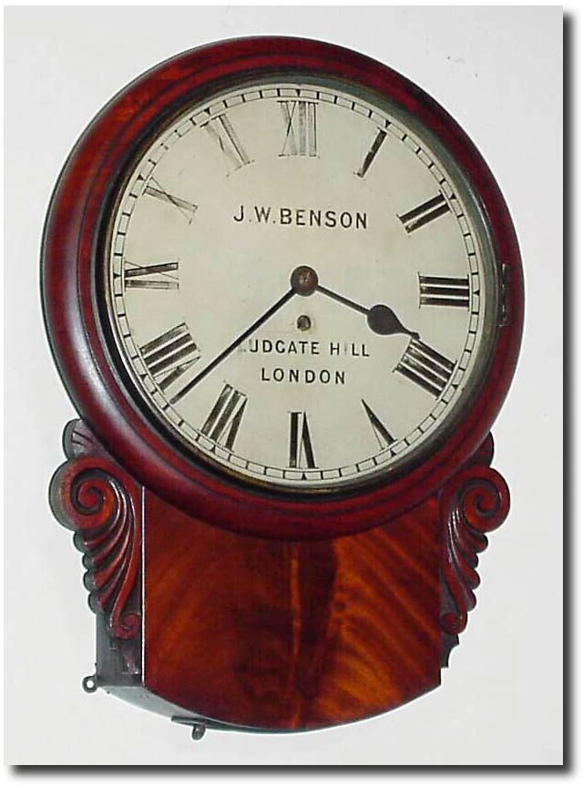 C.1920, English, J.W. Benson, London, 11' fusee drop dial in a well made case with crotch mahogany veneers in good condition and with original carved "ears' intact. — Antique Clocks Price Guide