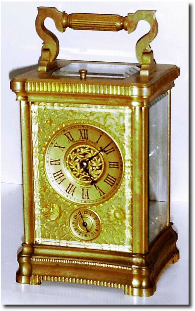C.1885, French, Brass Cased Carriage Clock, a stylized Angle Riche case with a gorge style bottom, all 4 sides slightly convex, and with a wonderful floral mask over the gilded dial. — Antique Clocks Price Guide