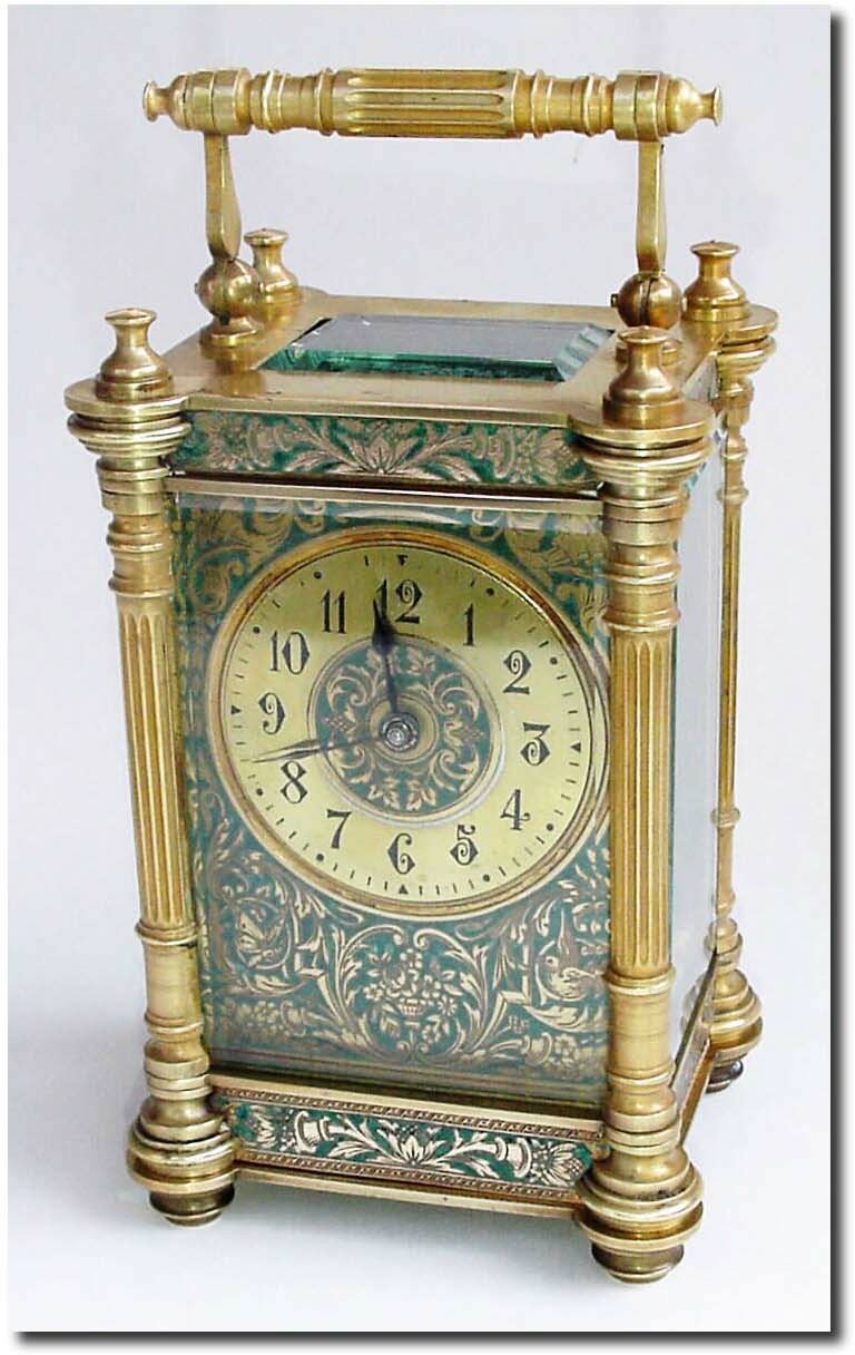 C.1900, French, Brass Cased Carriage Clock, in a fluted column case with a chased and gilded mask and dial. — Antique Clocks Price Guide
