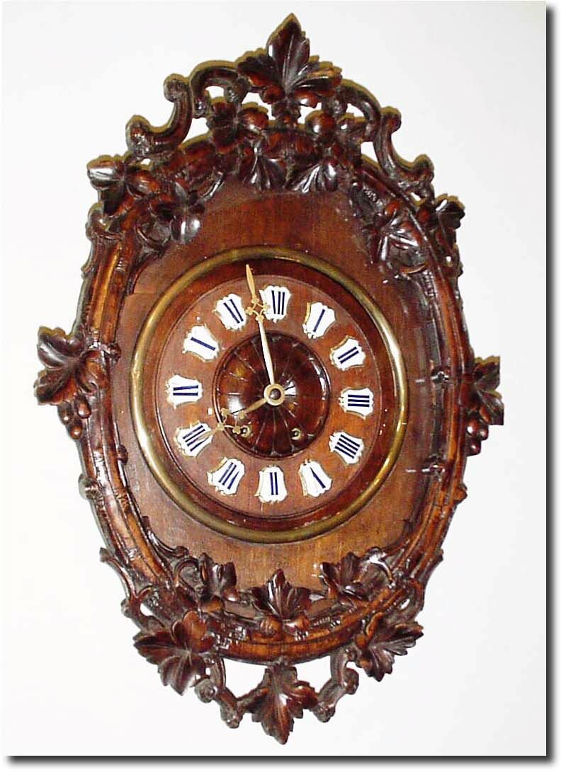 C.1890, French, Walnut cartel clock, the outer branch carved like a bent wood frame, and with ivy leaves all around as accents. — Antique Clocks Price Guide