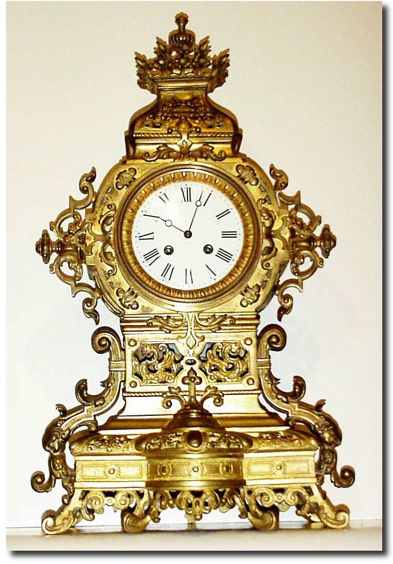 C.1890, French, Bronze Architectural mantel clock, with extra fancy detail., the central tower pierced and with profuse use of scrolls and teardrops, and two pierced baskets leading to a fluted finial at the top. — Antique Clocks Price Guide