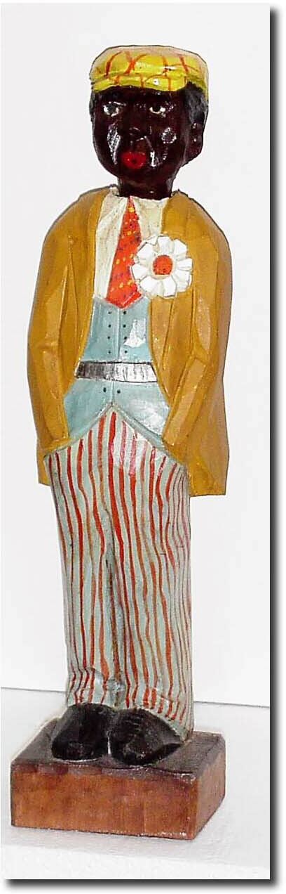 C.1967 (dated inside cover) German, Whistler depicting a black man in 1930"s attire, striped pants, orange tie and large flower in his lapel. — Antique Clocks Price Guide
