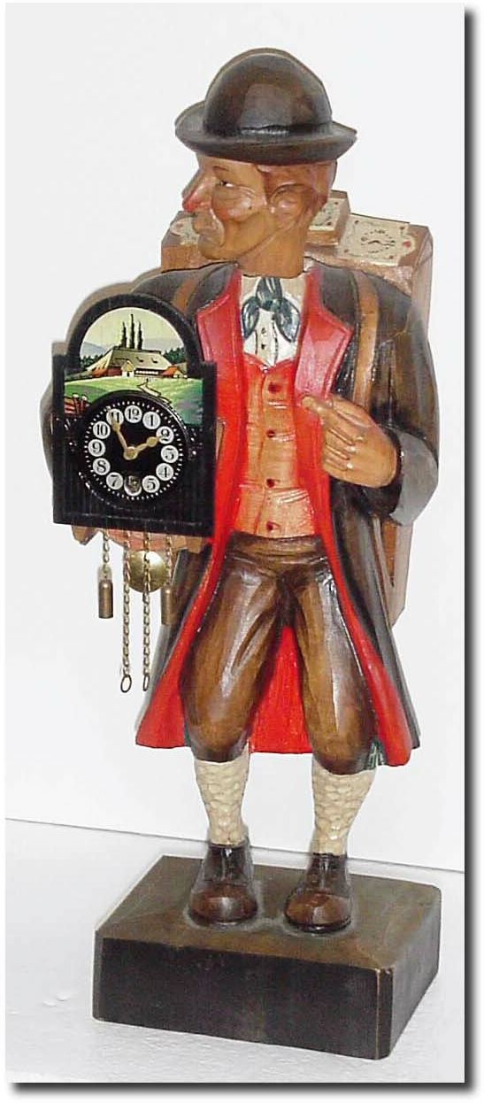 C.1960, German, "Clock Peddler', Whistler, carrying a load of clocks on his back and one in his right arm that actually works. — Antique Clocks Price Guide