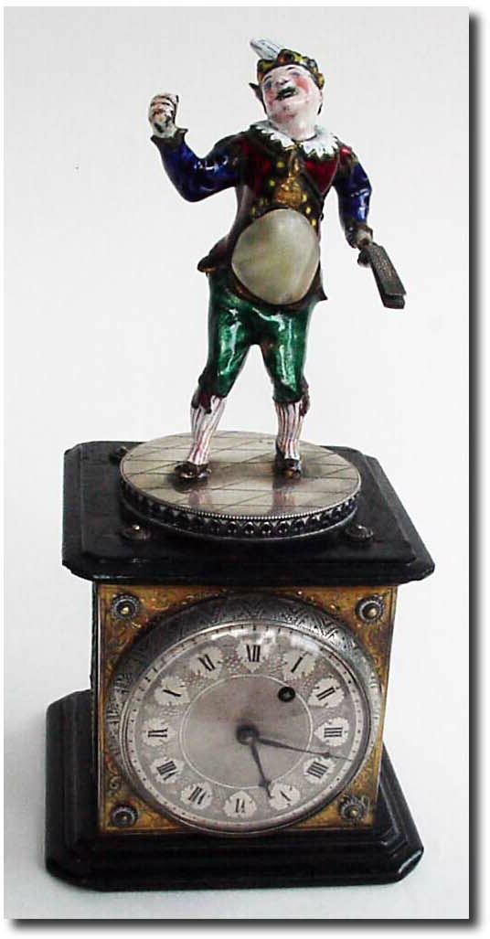 C.1790, Austrian, Enamel over copper Fasching Jester, with striped hat and spats and with a noise making clapper in his left hand. — Antique Clocks Price Guide