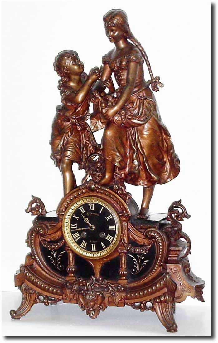 C.1890, French, Bronzed Spelter Figural clock of 2 young girls fresh from the orchard, with a basket of fruit, the girl on the left offering an apple to the girl in pigtails (with more fruit gathered in her skirt). — Antique Clocks Price Guide