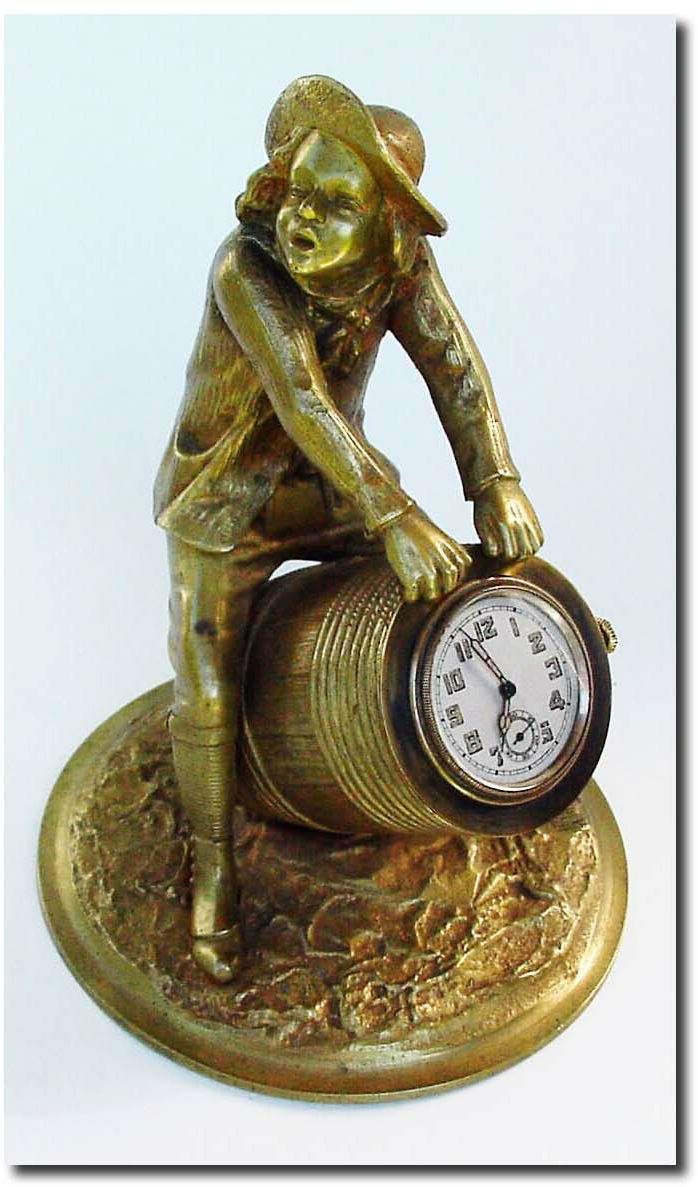 C.1910, French Bronze of a boy in mid pants, knee socks, spats and hat, straddling a wooden slat pickle barrel. — Antique Clocks Price Guide