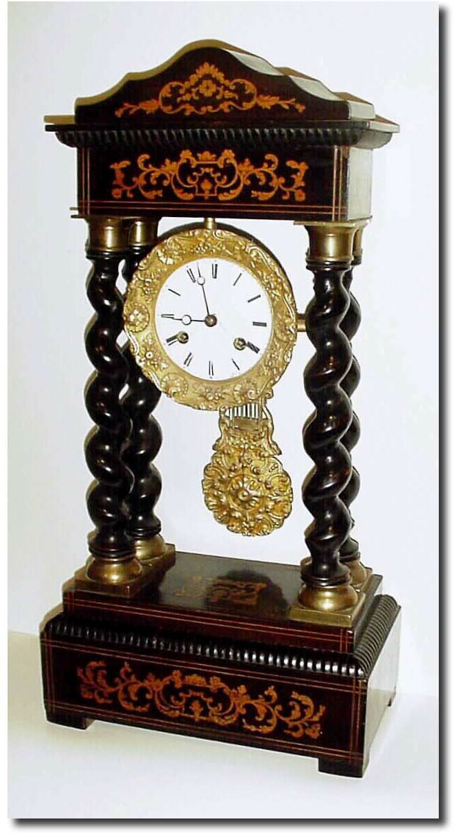 C.1870, French, Empire Style Mantel Clock, with 4 barley twist columns and an inlaid case, with some edge chips in the veneer. — Antique Clocks Price Guide
