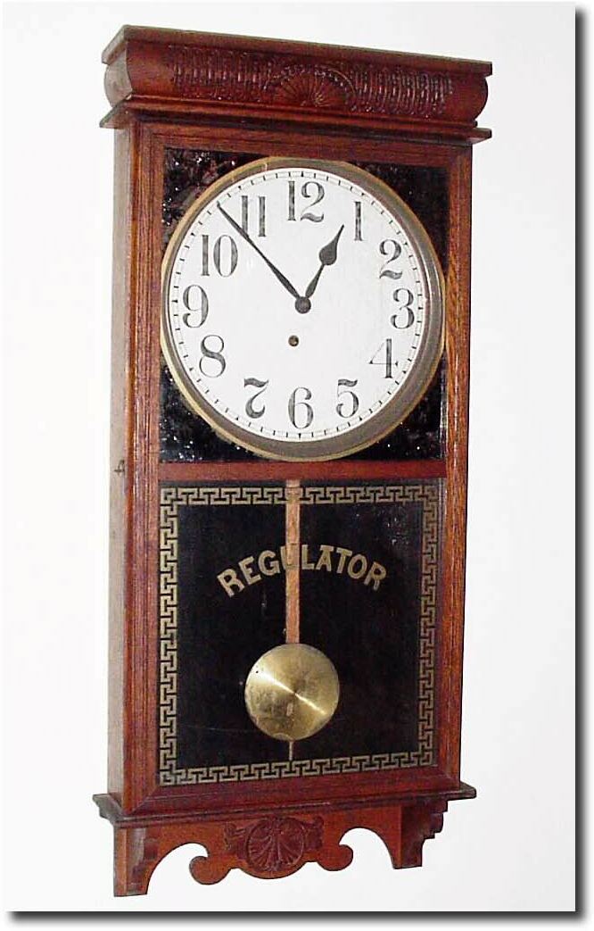 C.1907, E. Ingraham, "Western Union', solid oak store regulator with pressed top and bottom trim. — Antique Clocks Price Guide