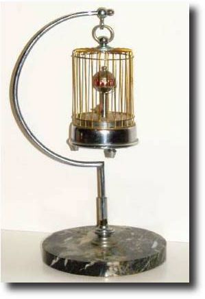 C.1948, Toyo Watch Co., Occupied Japan (signed movement), Bird-in-Cage, annular dial timepiece with original stand. — Antique Clocks Price Guide