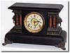 C.1900, E.N. Welch, Black Enamel over wood shelf clock in very good original condition, dirty.