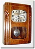 C.1930, French, Westminster Chime Wall clock in the Art Deco style, carved grapes and leaves adorning the door.