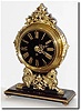 C.1900, French, Brass over wood mantel clock with a black glass dial.