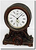 C.1910, Seth Thomas "Long Alarm', the top a pressed brass canister and the base of spelter with antique finish.