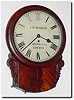 C.1920, English, J.W. Benson, London, 11' fusee drop dial in a well made case with crotch mahogany veneers in good condition and with original carved "ears' intact.